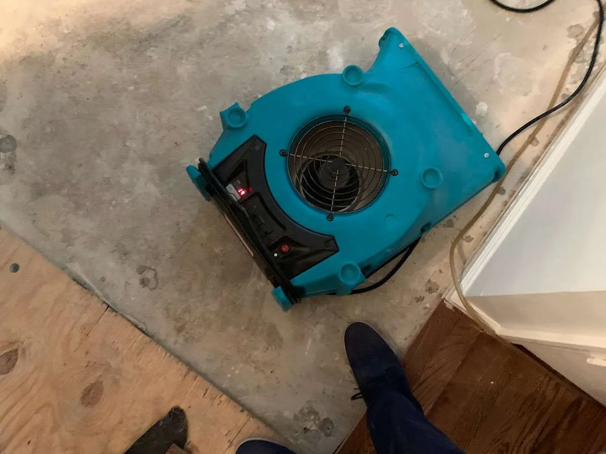 Air mover drying subfloor during Commercial Water Damage Restoration in Joshua